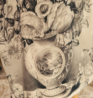 Closeup of an ornate black and white vase with bouquet fabric design