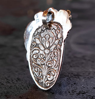 Necklace pendant reverse side features ornate floral engraving