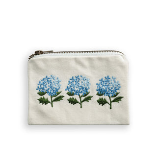 White cotton zippered pouch with embroidered design of three blue hydrangea blooms