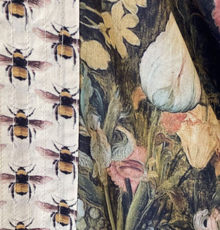 Closeup of the floral print of a garment and its contrasting bee print border