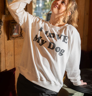 Model wears a white sweatshirt that says, "I LOVE My Dog" in large gray lettering