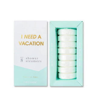 White and teal box of I Need a Vacation Shower Steamers with lid removed to show contents