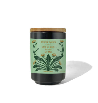 Candle jar with green label and floral artwork says, "Into the garden I go to lose my mind and find my soul"