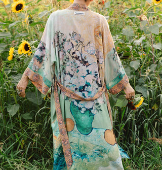 Model standing in a sunflower field wears a robe designed with elements of Vincent van Gogh's paintings