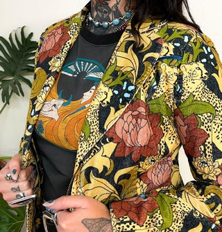 Closeup of the lapel on a zip-front jacket featuring print of cheetahs and flowers