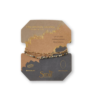 Dalmatian jasper and gold beaded bracelet/necklace wrapped around product card with gold foil design details
