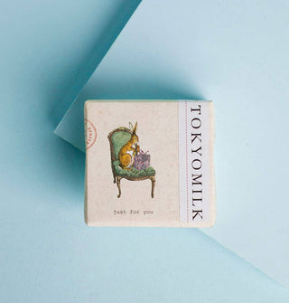 Wrapped square bar of TokyoMilk soap features illustration of a rabbit opening a purple present while seated on a green chair and the words, "Just for you" below it
