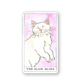 The Slow Blink card from the Kitten Oracle deck features an illustration of a fluffy white kitten with eyes closed on a pink watercolor background