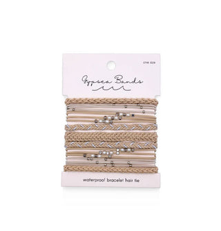 Set of woven Gypsea Bands Waterproof Bracelet Hair Ties in  beige and white tones, some of which feature silver and pearlescent beads