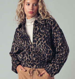 Model wears a zip-front collared leopard print jacket with pockets and an elastic waist