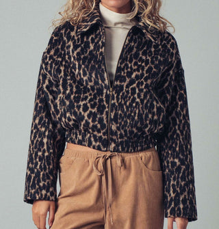 Model wears a zip-front collared leopard print jacket with pockets and an elastic waist