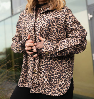 Model wears a button-down leopard print jacket with cuffs and collar