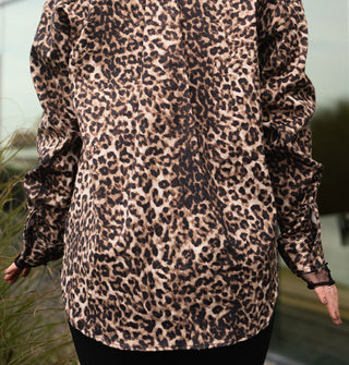 Model facing away from the camera wears a leopard print jacket