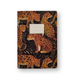 Notebook cover illustrated with leopards surrounded by ferns and lightning bolts says, "Notebook" in gold foil lettering inside a central white title block