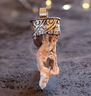 Light orca agate chunk pendant set in engraved silver top with round bail