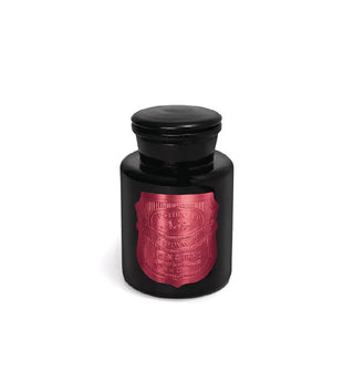 Black apothecary-style candle jar with metallic pink shield-shaped label