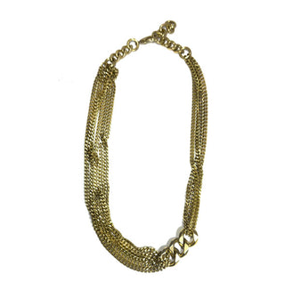 Gold-toned necklace with multiple strands of narrow curb chain on either side connected by three large curb links off-center to the right