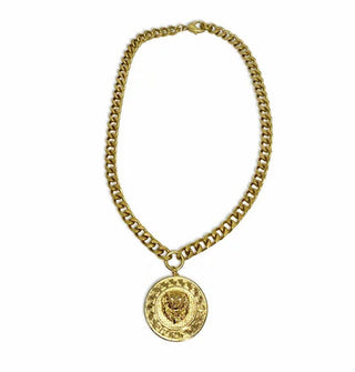 Round embossed gold lion face medallion hangs from thick gold-toned curb chain