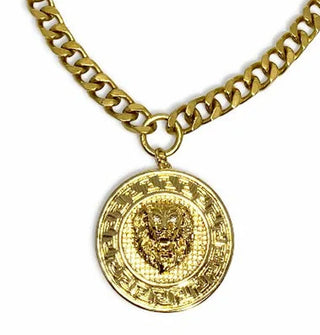 Round embossed gold lion face medallion hangs from thick gold-toned curb chain