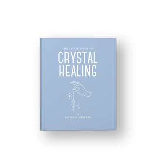 Light blue cover of The Little Book of Crystal Healing with a central line drawing of a hand holding a crystal by a string with stars on either side of it