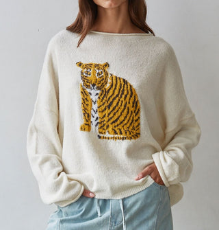 Model wears a white sweater with tiger graphic