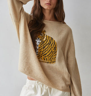 Model wears a tan-colored sweater with tiger graphic