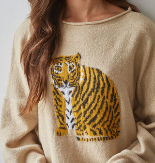 Model wears a tan-colored sweater with tiger graphic