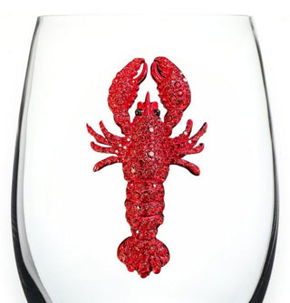Red jewel-encrusted lobster decal on the clear bowl of a wine glass