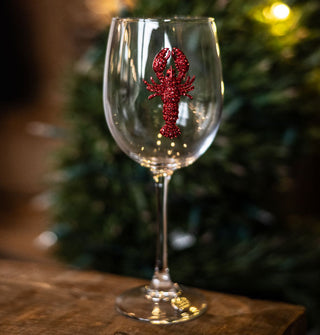 Clear wine glass features a red jewel-encrusted lobster decal on its bowl