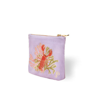 Square light purple velvet pouch with gold zipper features an embroidered design of an orange lobster with green and pink coral