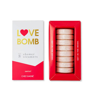 Red and white box of Love Bomb Shower Steamers with lid removed to show contents inside