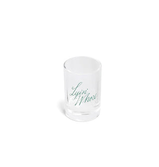 Clear shot glass says, "Lyin' Whore" in green script lettering set at a tilt