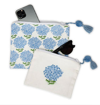 Set of two blue and white hydrangea pouches, the larger unzipped with a cell phone sticking out, the smaller unzipped with a pair of sunglasses sticking out