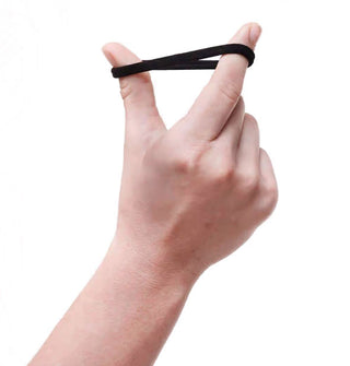 Model's hand stretches out a black recycled nylon hair elastic strung around thumb and index finger