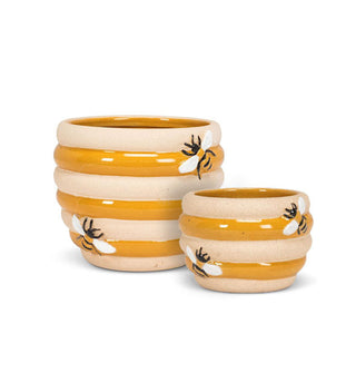 Small and large ribbed ceramic beehive-shaped planters with painted embossed bee accents