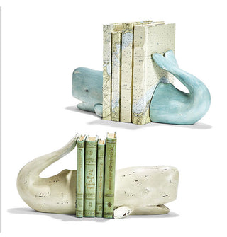 Two sets of whale-shaped bookends, one blue and one white, are staged with vertical stacks of four books each