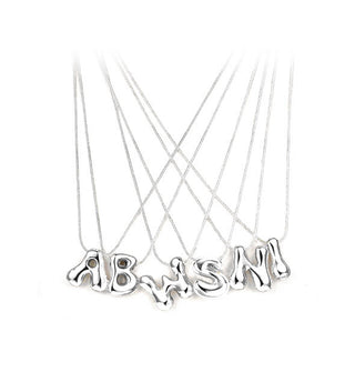 Grouping of silver necklaces with cable chains and bubble letter pendants