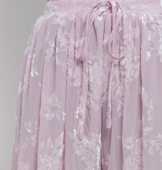 Closeup of flocked velvet detail on apair of elastic tie-waist pants