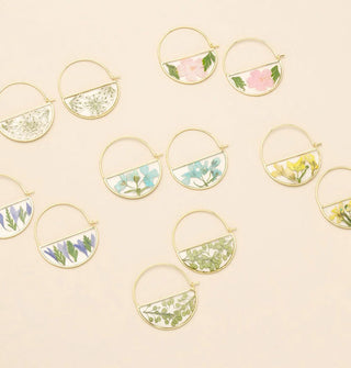 Series of gold hoop earrings featuring semicircle resin-encased pressed flowers and leaves
