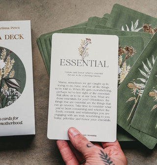 Model's hand pulls an Essential card from The Mama Deck