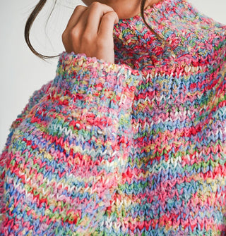 Closeup of multicolored marled knit of a long-sleeved turtleneck sweater