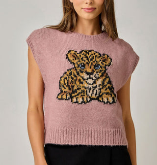 Model wears a dusty pink sweater vest with blue-eyed leopard cub graphic and ribbed hems
