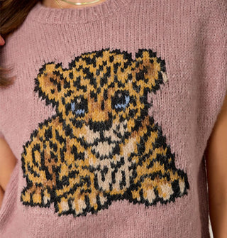 Closeup of the blue-eyed leopard cub graphic on a dusty pink sweater vest with ribbed neckline