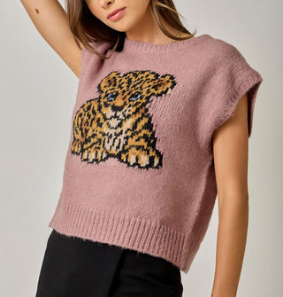 Model wears a dusty pink sweater vest with blue-eyed leopard cub graphic and ribbed hems