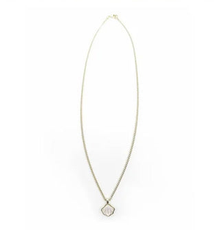 A white mother of pearl seashell charm hangs on a thin gold curb chain