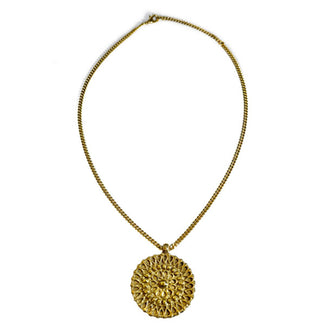 Gold-toned round medallion with intricate patterning on thin curb chain with extender