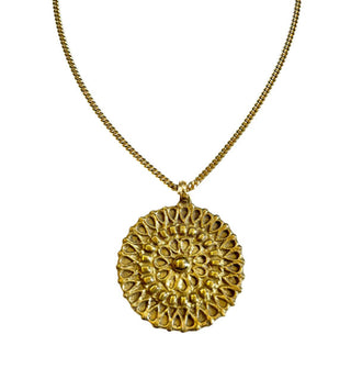 Gold-toned round medallion with intricate patterning on thin curb chain
