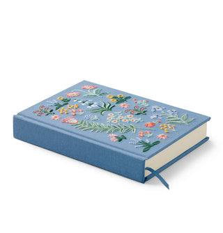 Three-quarter view of blue floral embroidery journal