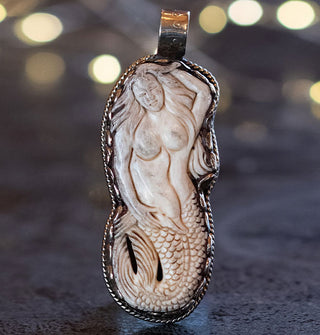 Carved bone mermaid necklace pendant in silver setting