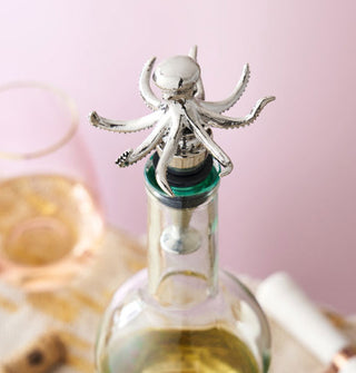 Silver octopus stopper placed in the opening of a bottle of white wine